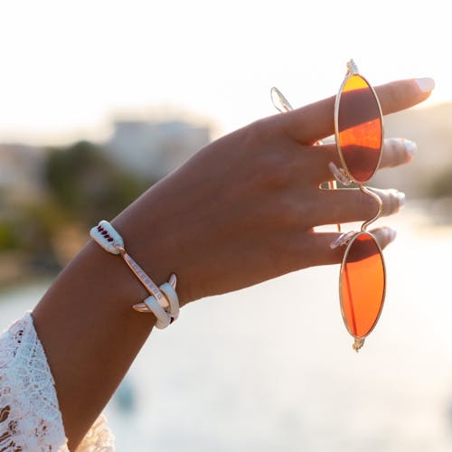 Close Up Photo of Sunglasses on Hand