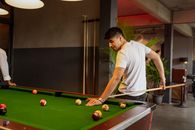 Man in White T-shirt Playing Billiard