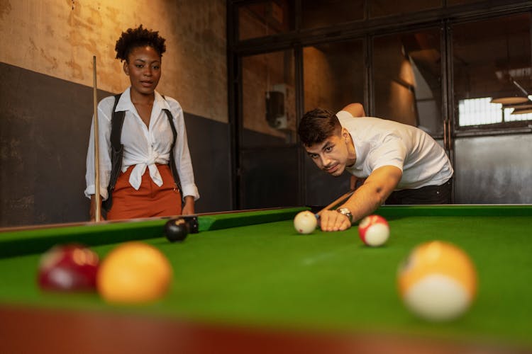 Woman And Man Playing Pool