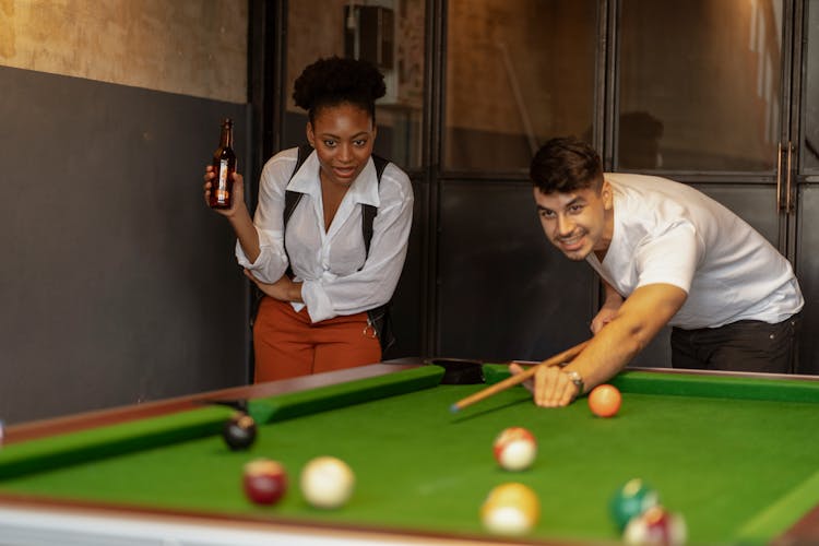 Man And Woman Playing Billiards