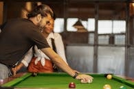 Man in Black T-shirt Playing Billiard