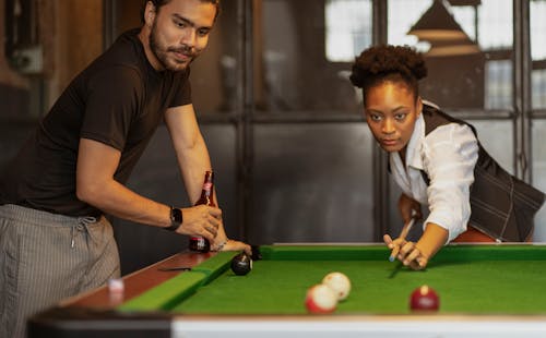 Woman and Man Playing Snooker