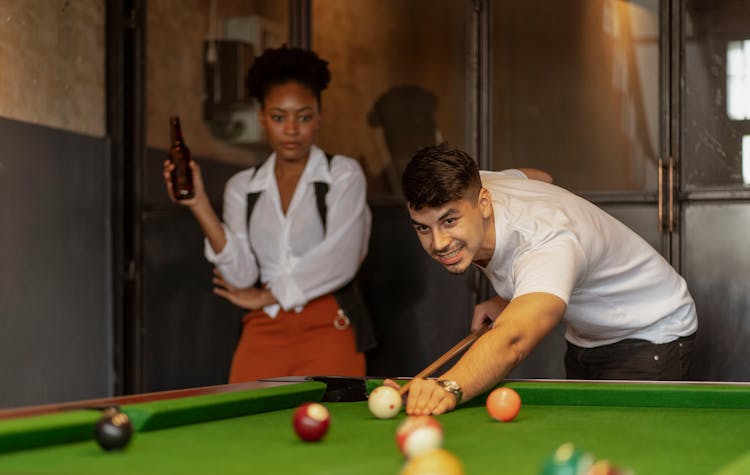 Woman Watching Man Play Snooker 