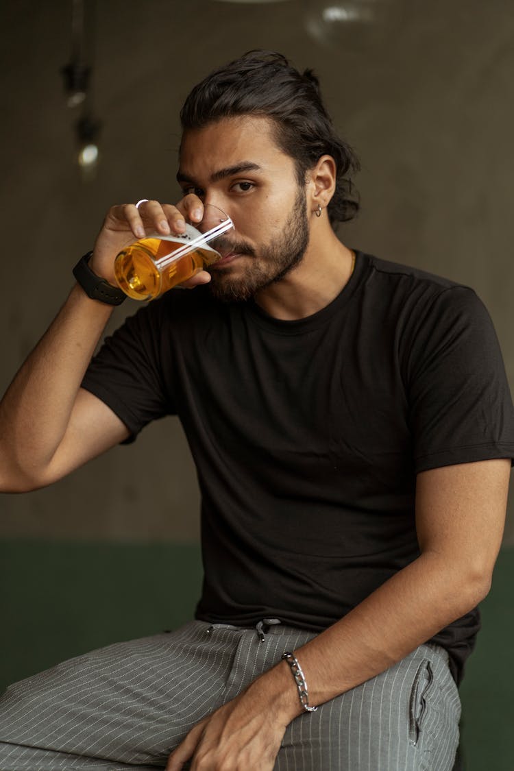 Man With Dark Features Drinking Beer