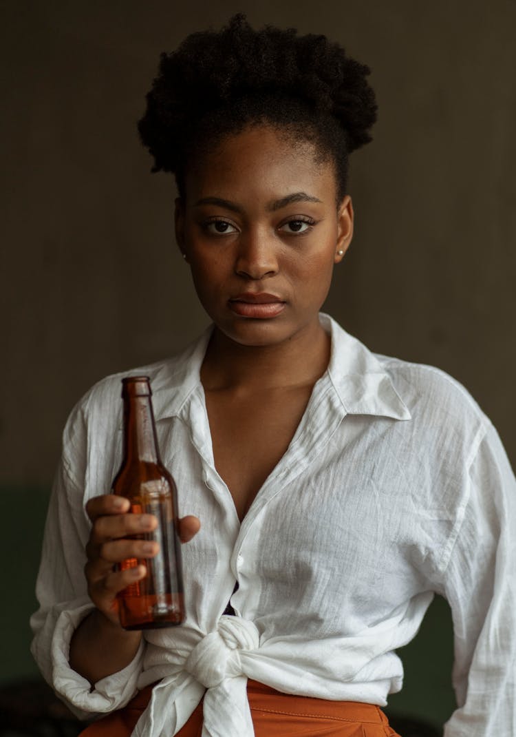 Portrait Of A Woman Holding A Beer Bottle