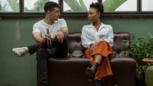 Woman and Man Talking on Sofa