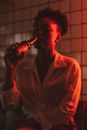 Man in Pink Dress Shirt Drinking Coca Cola