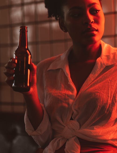 Woman Holding Bottle of Beer