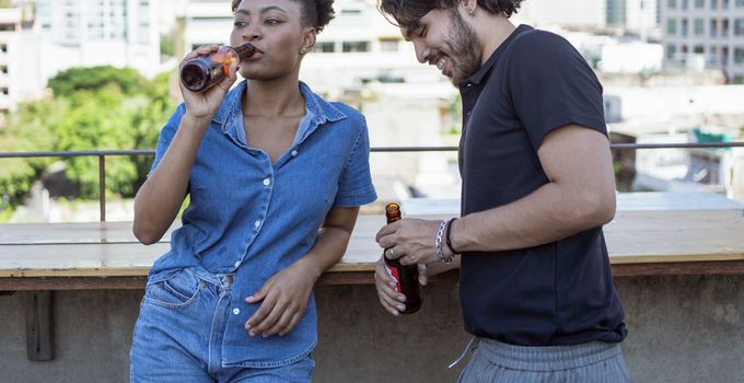 Man and Woman Drinking Beer from Bottles