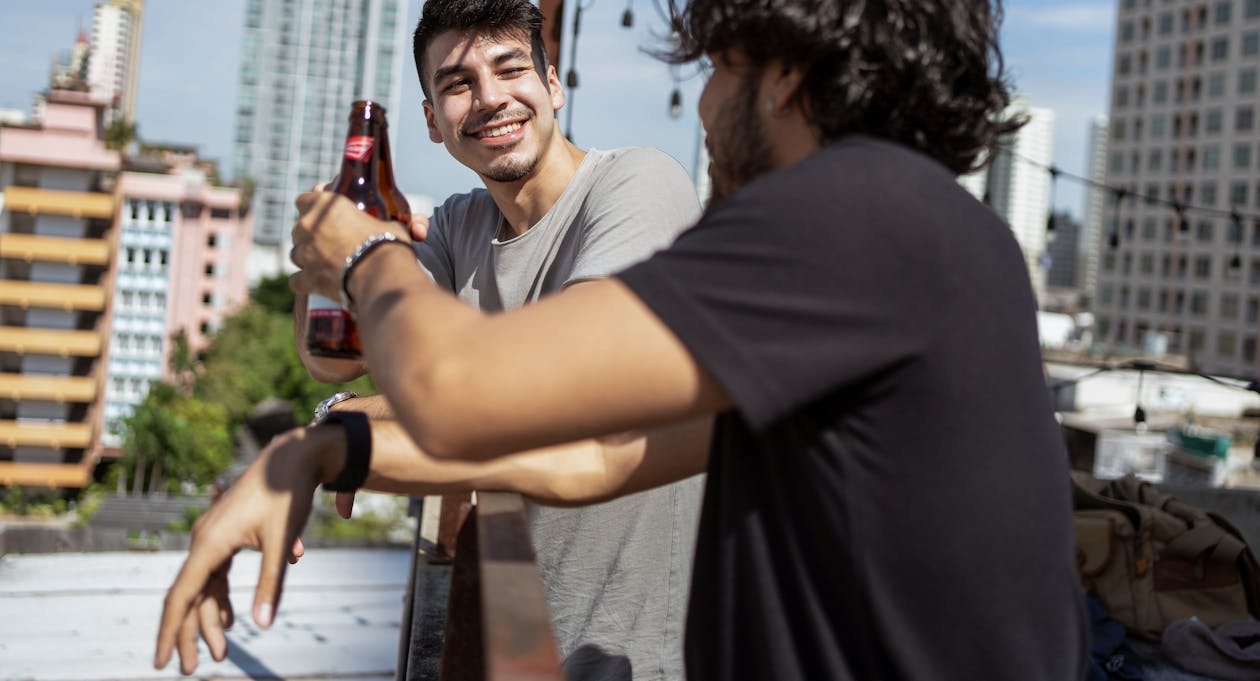 Two Men Holding Beer Bottles