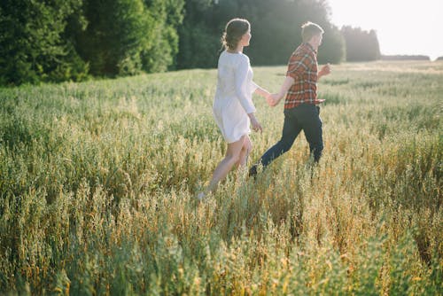 A Couple Running in the Field