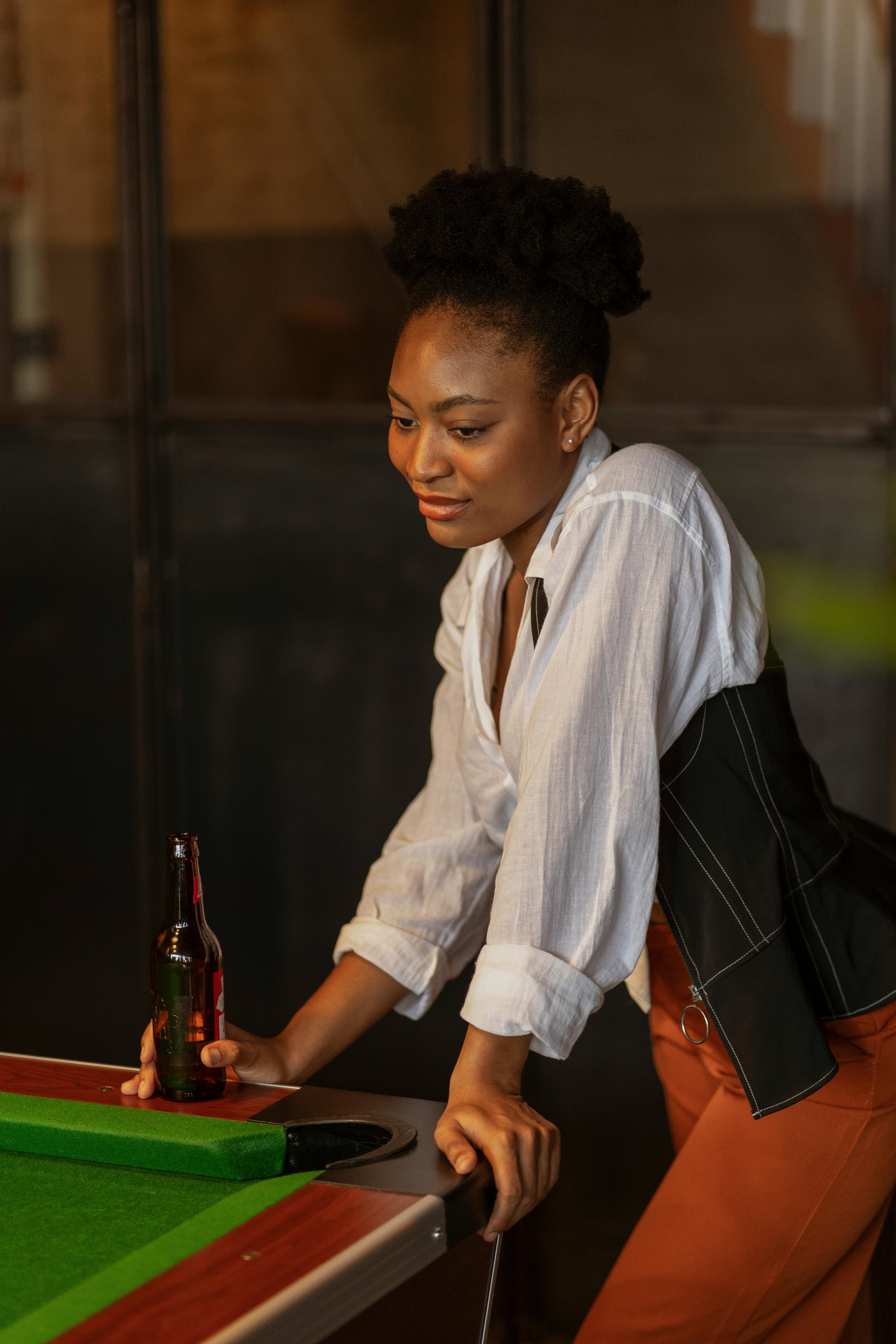 woman with beer by snooker table