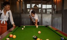 Couple Playing Snooker at Bar
