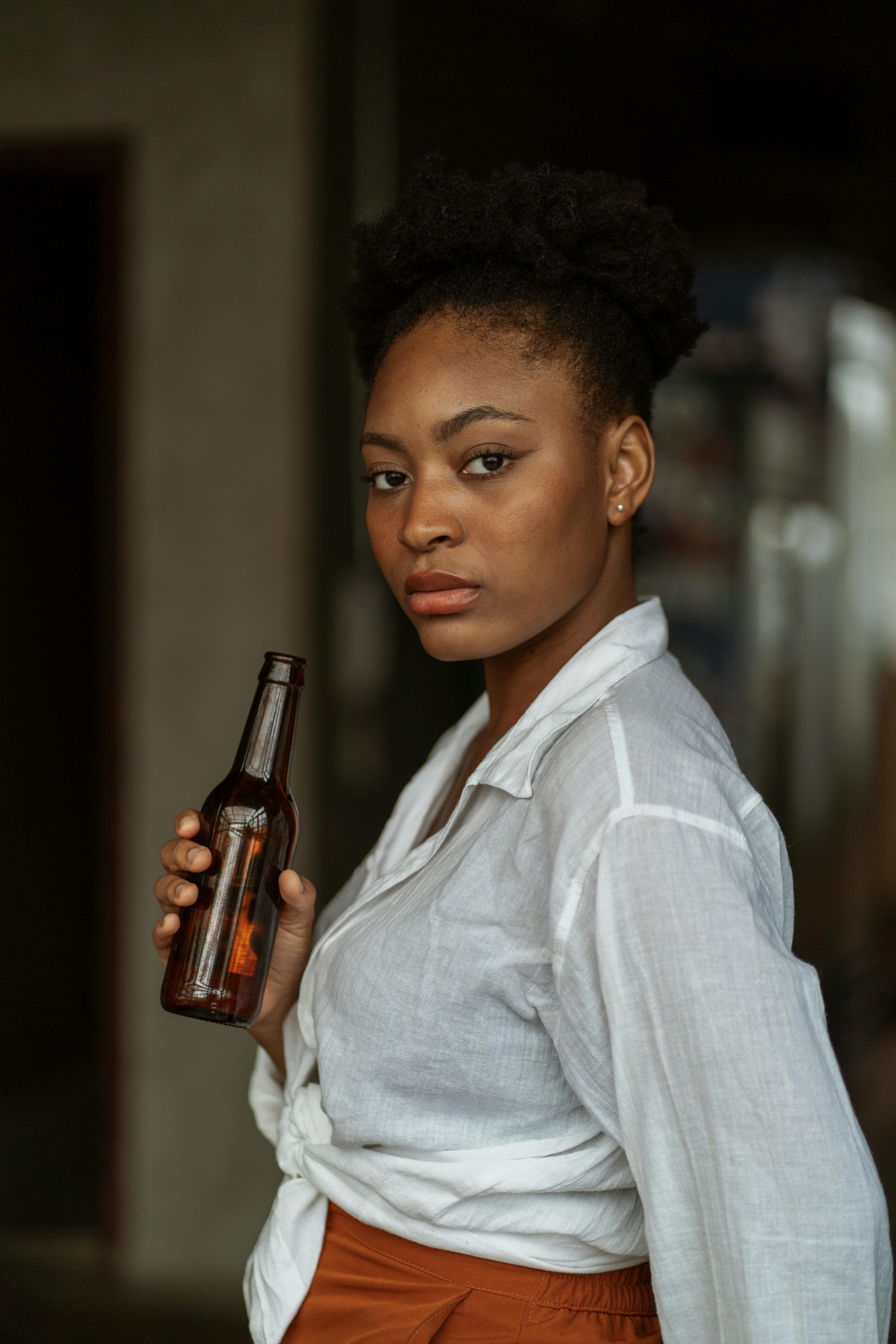 Man in White Dress Shirt Holding Bottle