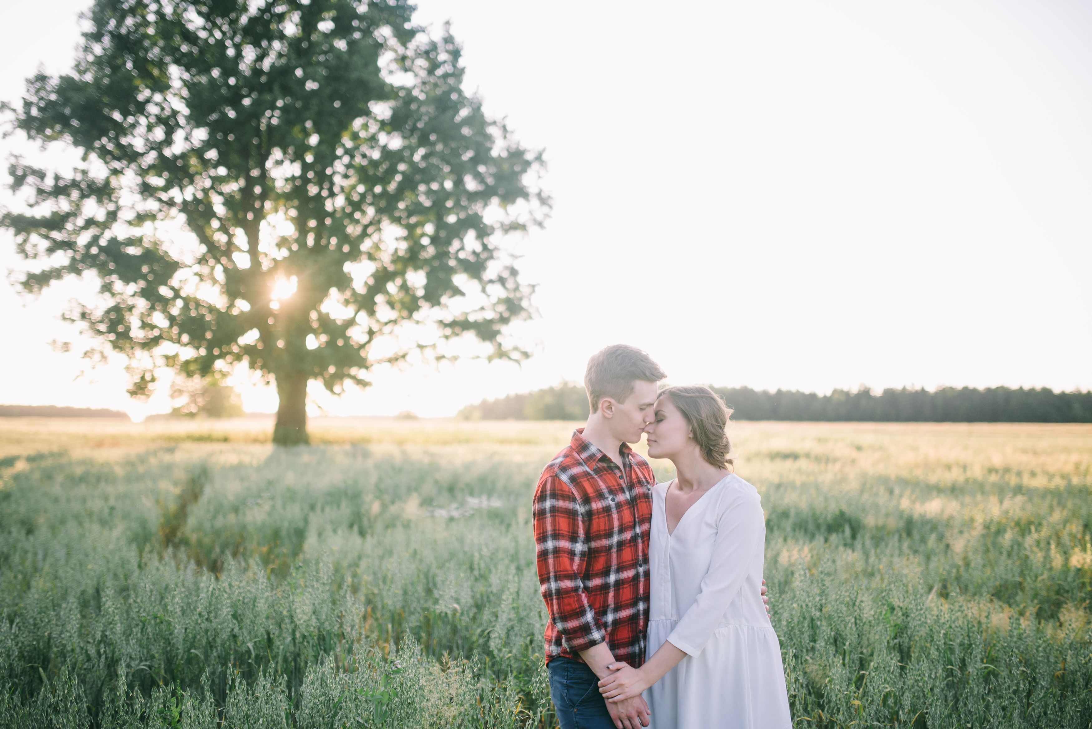Man and Woman Standing on Green Grass Field · Free Stock Photo