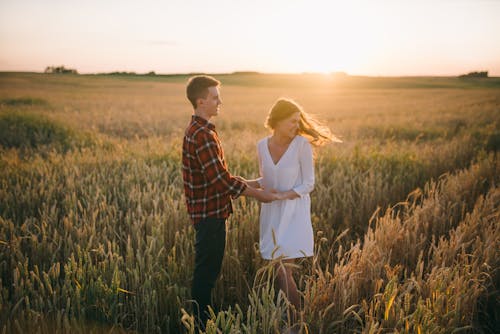 A Couple Holding Hands in the Farm Field