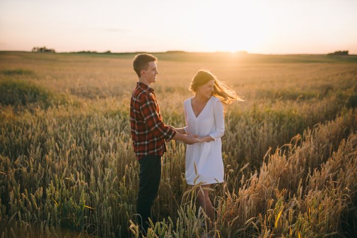 Pair holding hands in a wheat field at sunset — Leeloo The First on Pexels