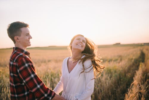 Man and Woman Standing on the Field