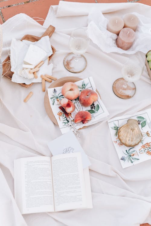 Fruit, Candles and Book on a Picnic Blanket on a Roof