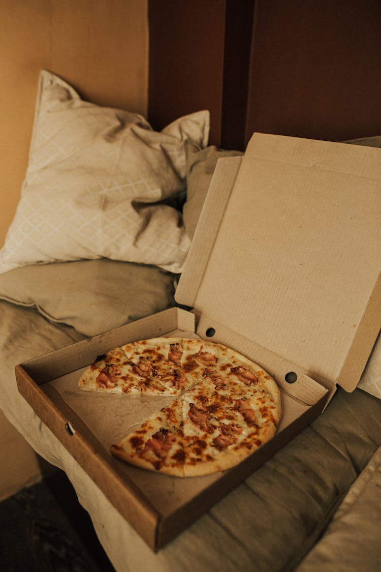 Pizza In A Box On Top Of A Sofa