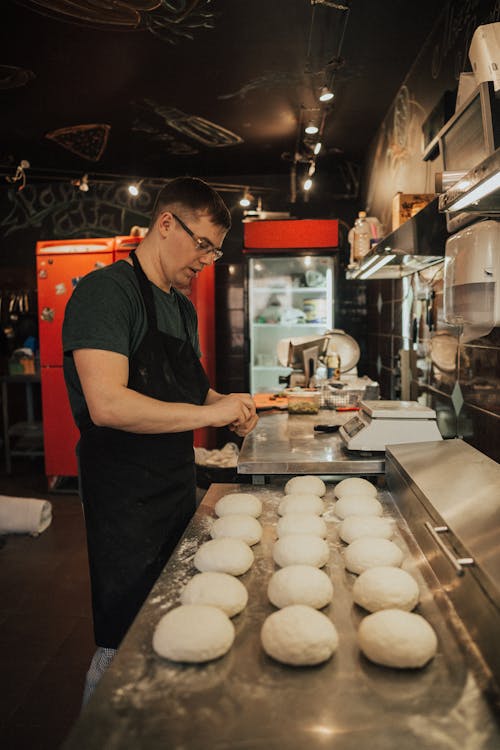 Man Wearing an Apron Preparing Food