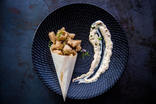 Free Top view of gourmet deep-fried snack with side sauce on a stylish plate. Stock Photo