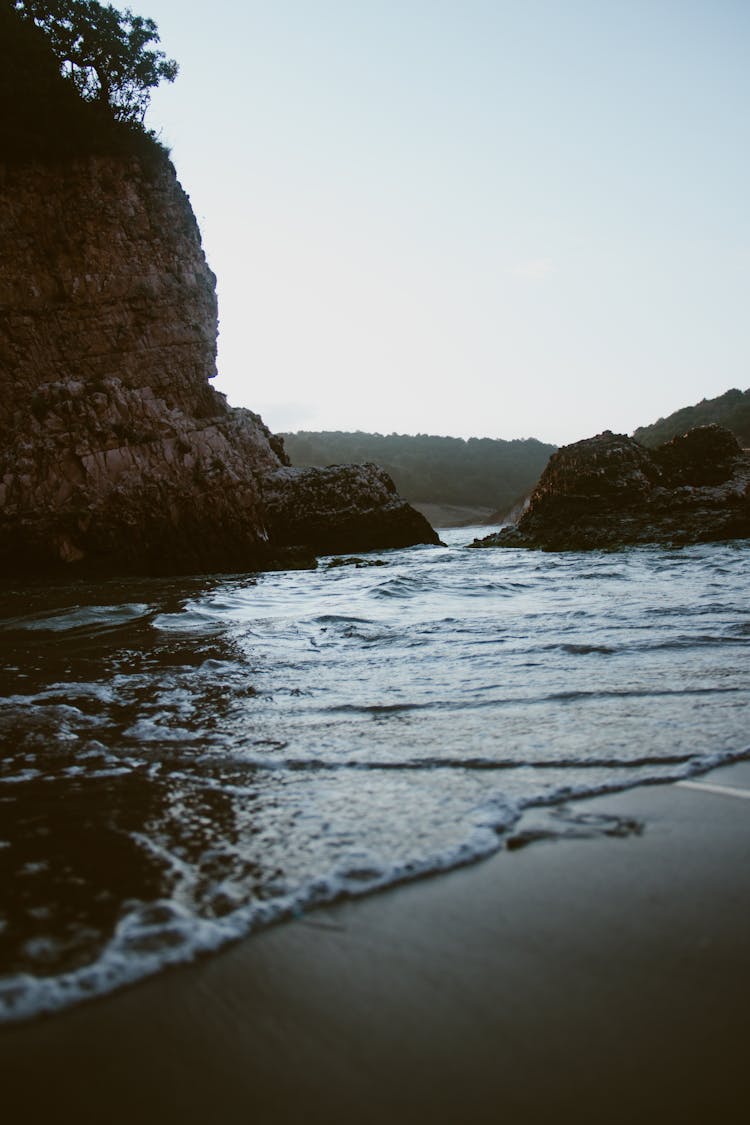 Brown Rock Formation On Sea Water