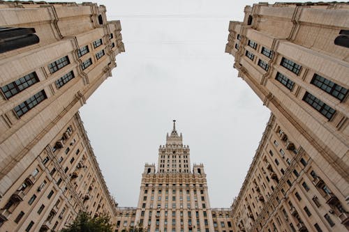 Low Angle Shot of Brown Concrete Buildings with Glass Windows 