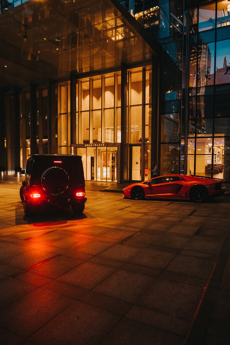 Cars On A Driveway Beside A Building