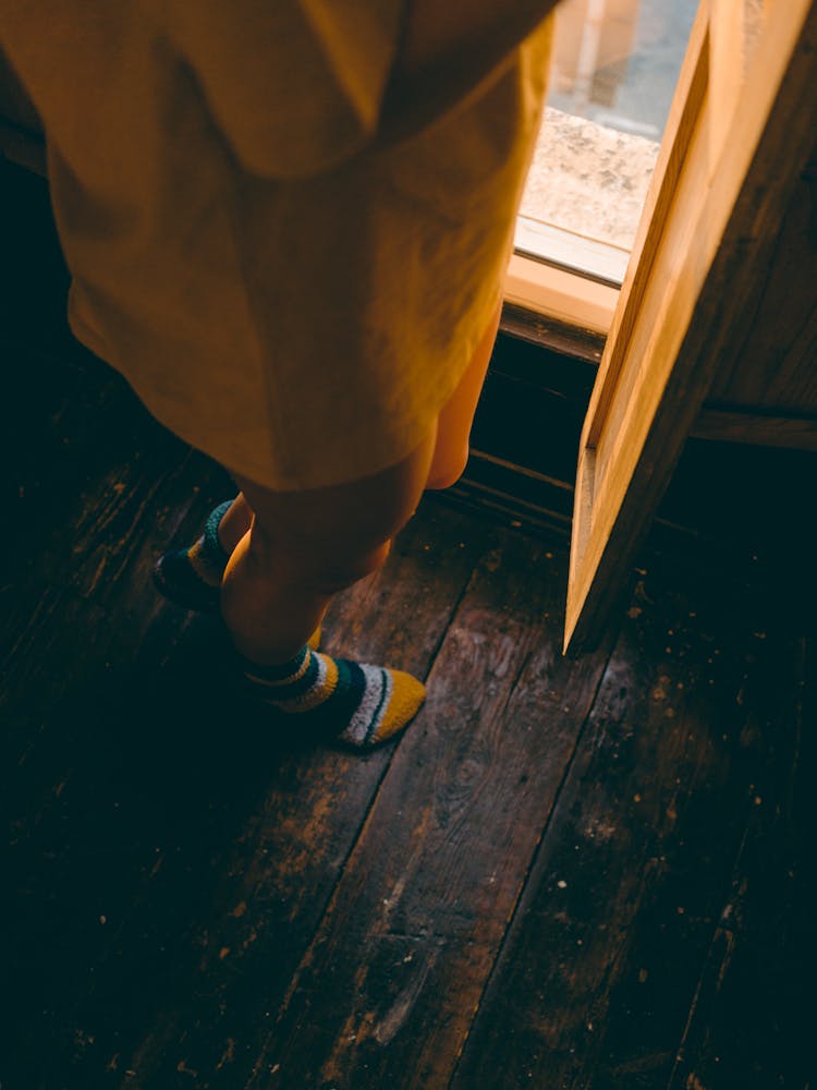 Person In Yellow Oversized Shirt Wearing Colorful Socks 