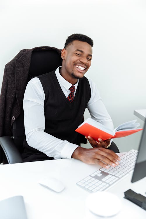 Smiling Man Using a Computer