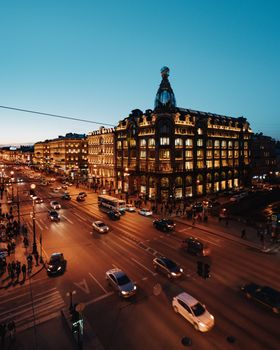 Capture of St. Petersburg's bustling street and landmark building at dusk.