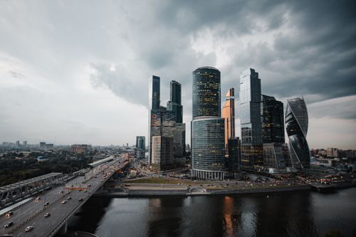 Free A dramatic view of Moscow's skyscrapers under a cloudy sky, reflecting modern architecture. Stock Photo
