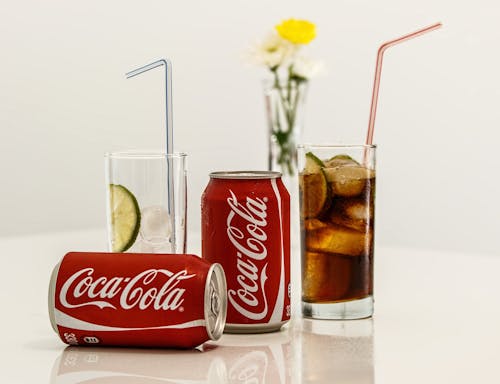 Free Coca Cola Cans and Glasses With Lines Stock Photo