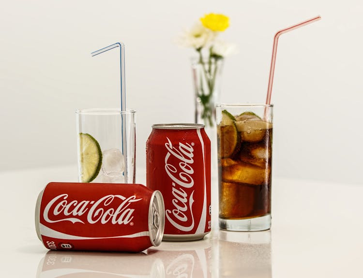 Coca Cola Cans And Glasses With Lines