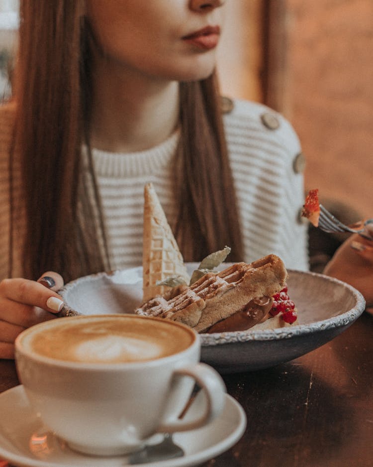 Woman Eating Waffle With Coffee Drink For Breakfast