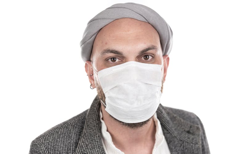 Man With Brown Eyes Wearing White Face Mask