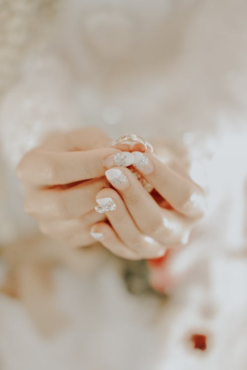 Close Up Photo of a Person Holding a Ring