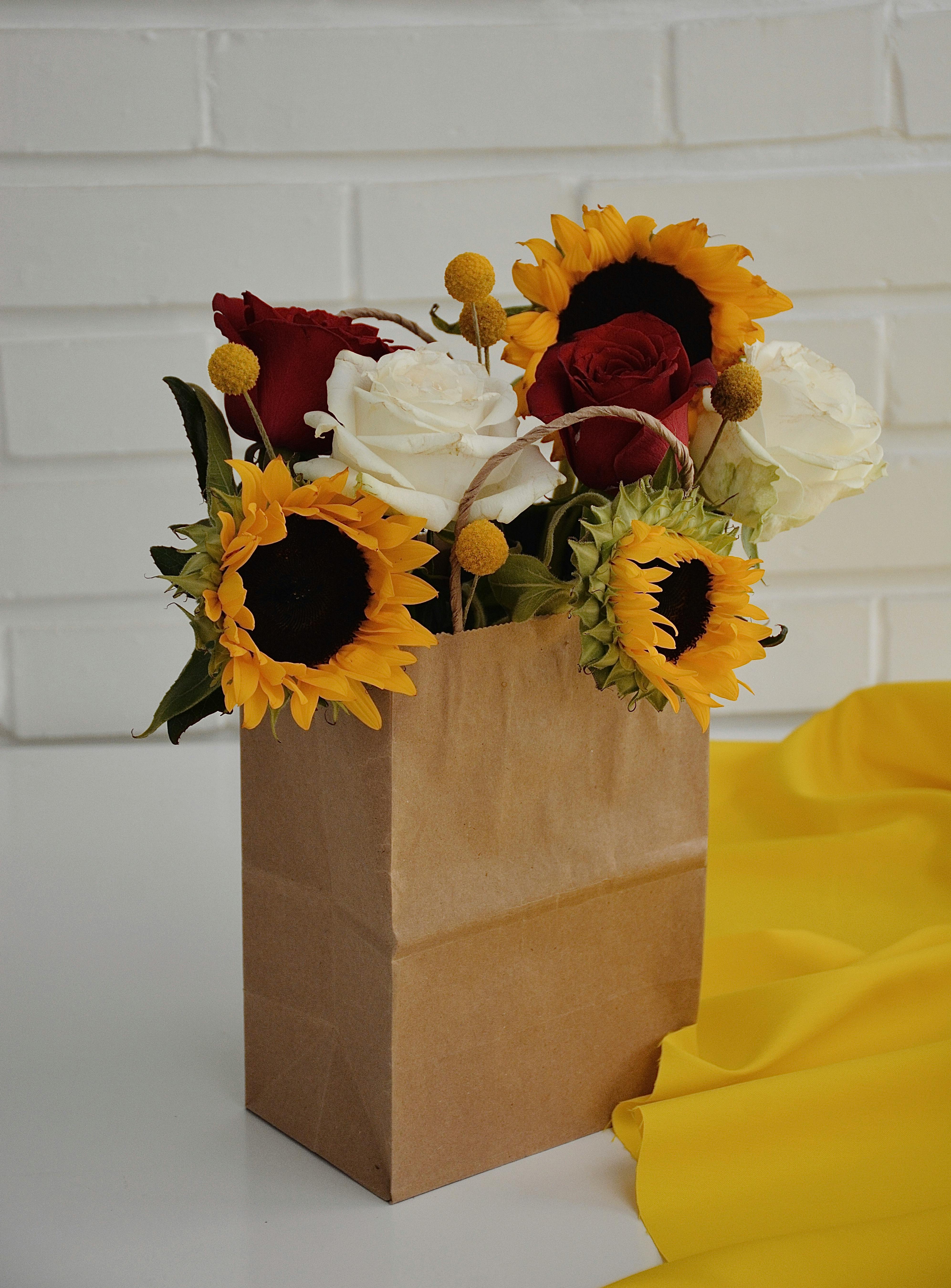 Beautiful flowers bouquet in gift light green paper bag with ribbons on  yellow-green background. 18105829 Stock Photo at Vecteezy