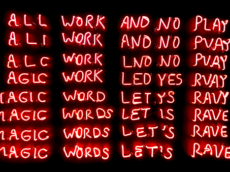 Colorful neon sign displaying creative phrases and words against a black background.