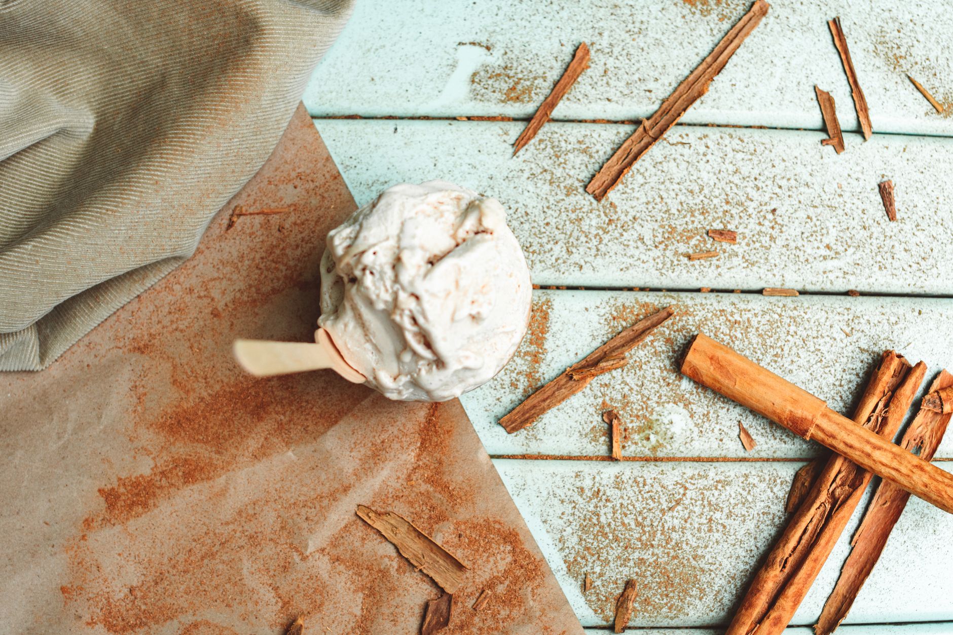 Maple spice ice cream in a bowl with cinnamon sticks and walnuts