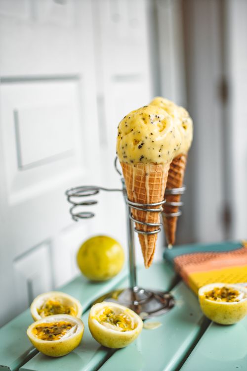 Free Close-up of passion fruit ice cream cones with fresh fruits and creamy texture. Stock Photo