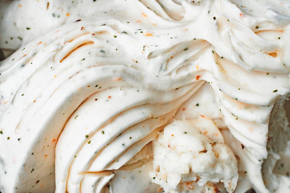 Delicious creamy vanilla ice cream with textured swirls and flecks, captured in a close-up view.