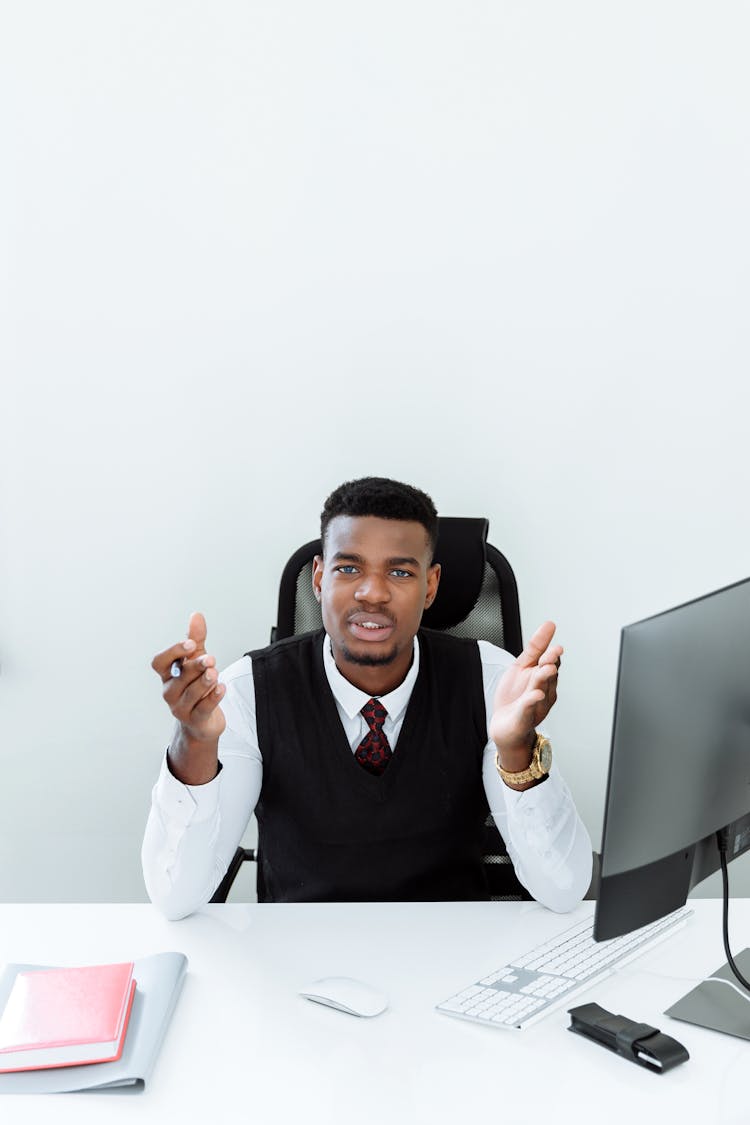 A Man In A Black Vest Talking