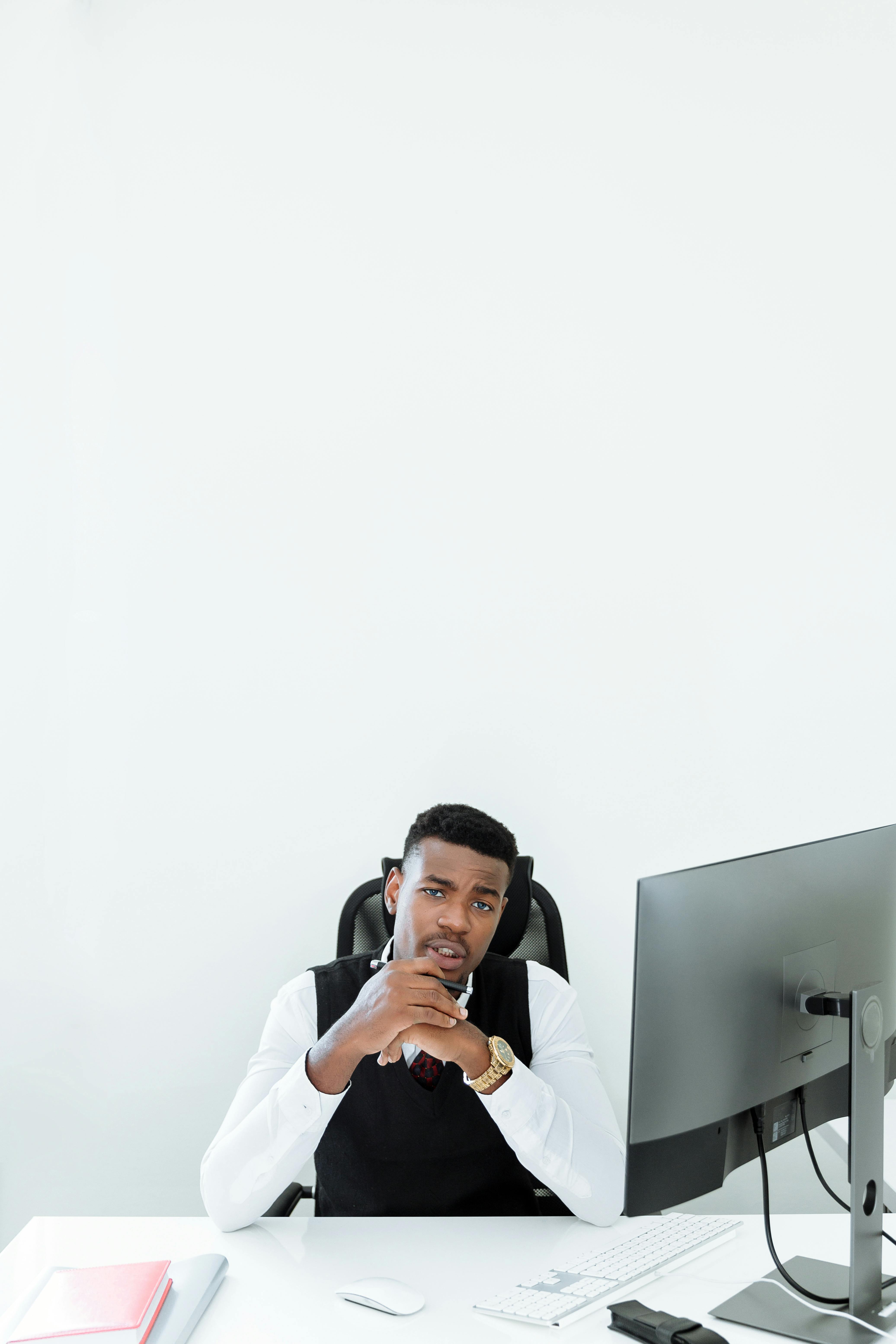 man in white dress shirt using black smartphone