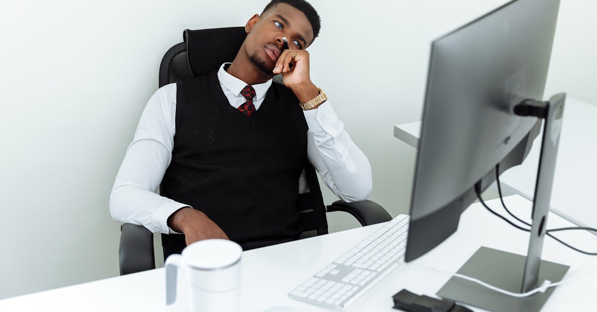 Man in Black Suit Jacket Sitting on Black Chair