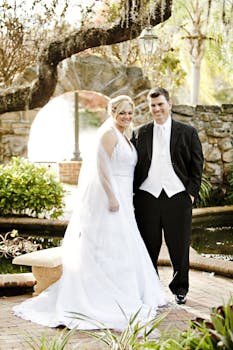 Couple Standing Near Gray Rock Fence during Daytime
