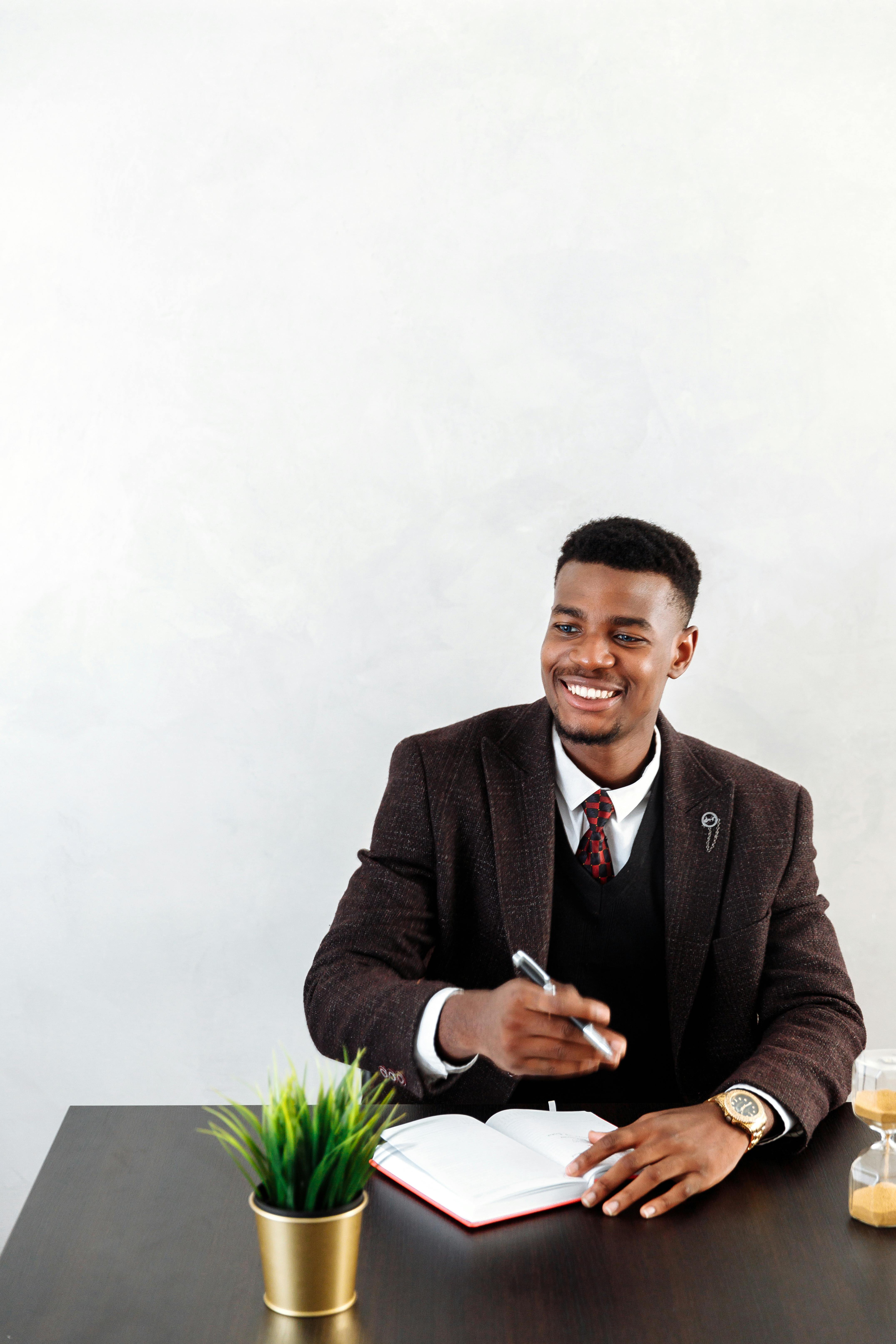 man in black suit jacket smiling