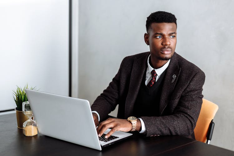 Man In Black Suit Jacket Using Laptop Computer