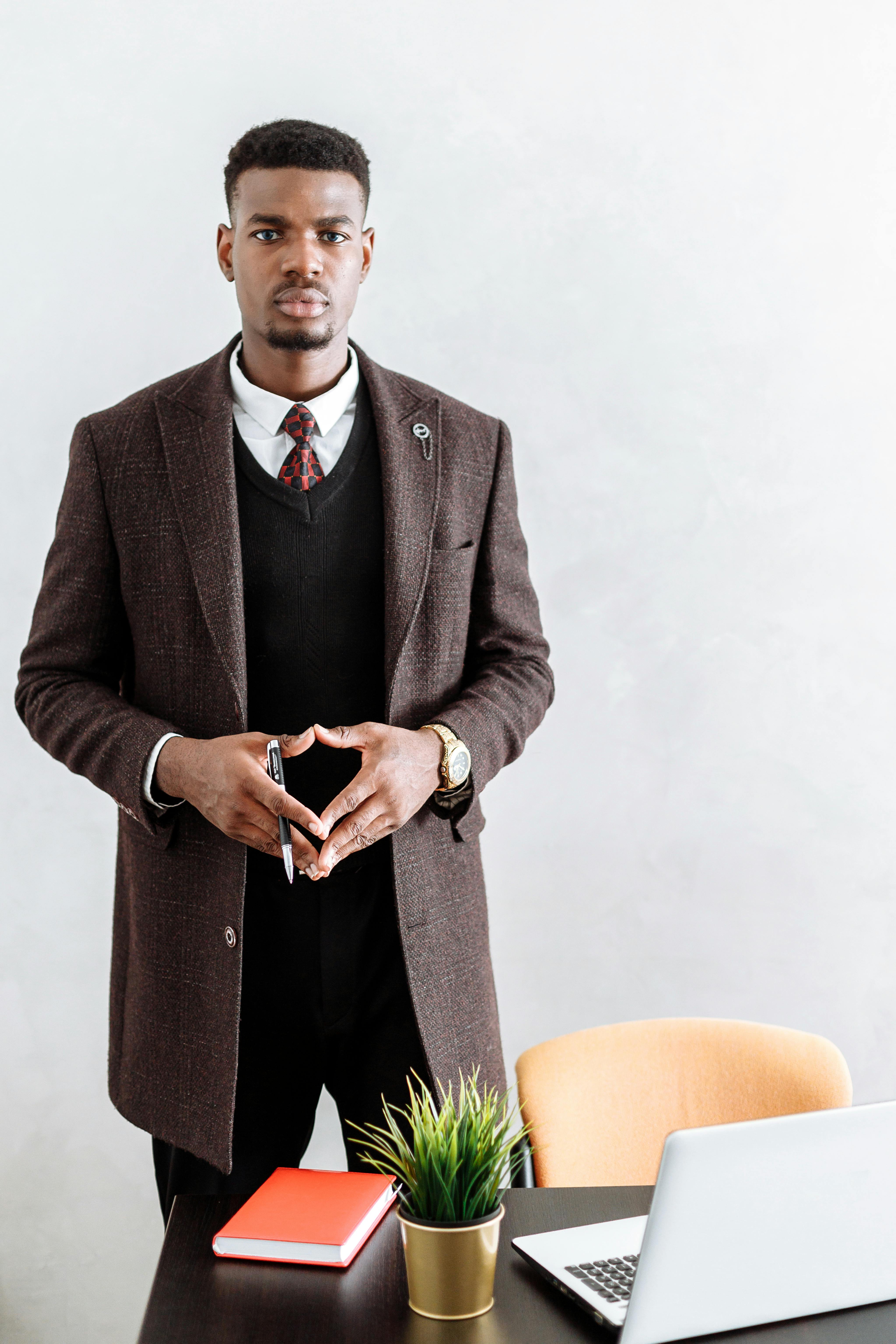 man in black suit jacket and black pants